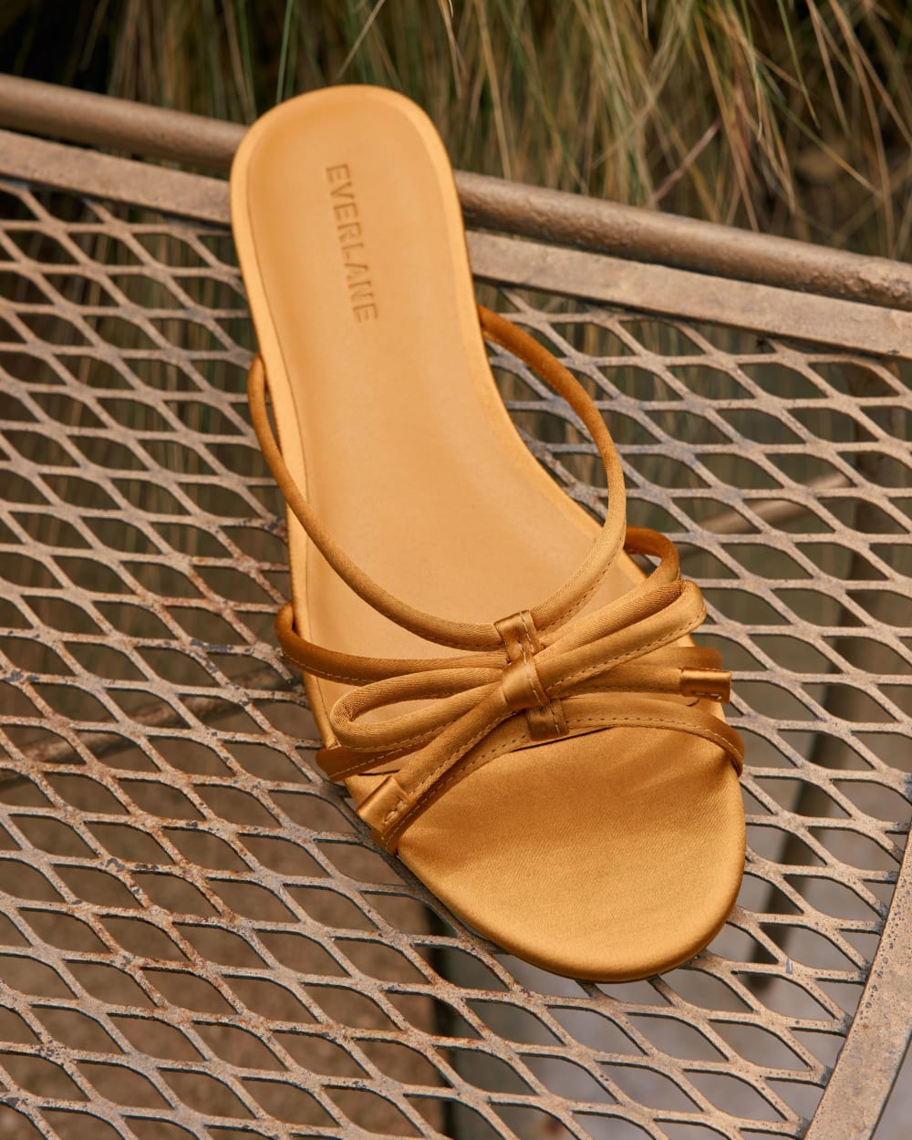 womens-leather-bow-sandal-golden-sun-satin | editorial